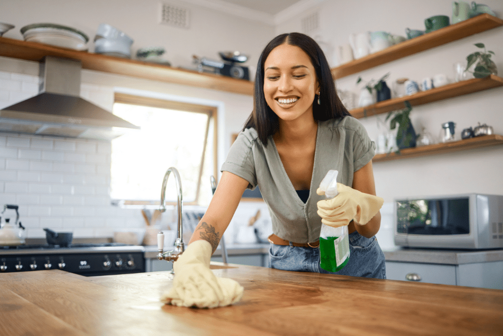 Woman cleaning kitchen counter